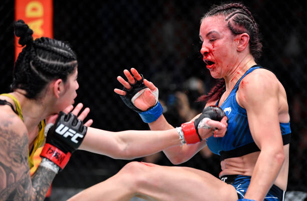 Ketlen Vieira of Brazil and Miesha Tate trade strikes in a bantamweight fight during the UFC Fight Night event at UFC APEX on November 20, 2021 in...