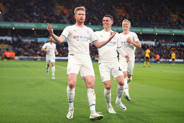 Kevin De Bruyne of Manchester City celebrates scoring his side's third goal with team-mate Phil Foden during the Premier League match between...