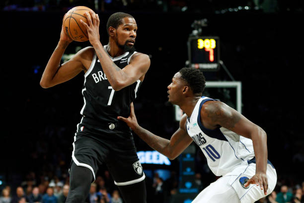 Kevin Durant of the Brooklyn Nets dribbles against Dorian Finney-Smith of the Dallas Mavericks during the first half at Barclays Center on October...