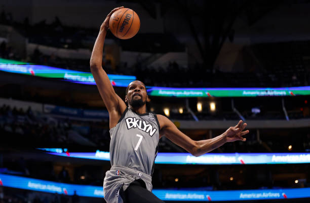 Kevin Durant of the Brooklyn Nets goes up for a slam dunk against the Dallas Mavericks in the first half at American Airlines Center on December 7,...