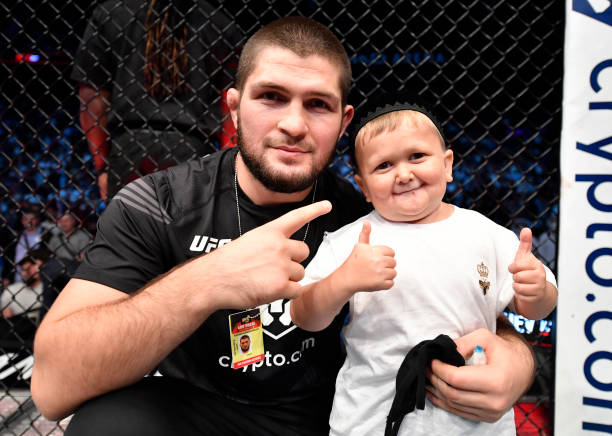 Khabib Nurmagomedov and Hasbulla Magomedov celebrate in the Octagon after Islam Makhachev's victory over Dan Hooker in a lightweight fight during the...
