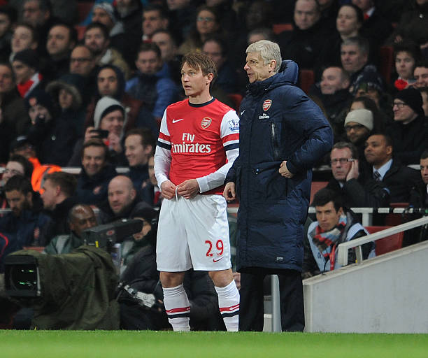 Kim Kallstrom of Arsenal with Arsene Wenger the Arsenal Manager during the match between Arsenal and Swansea City in the Barclays Premier League at...