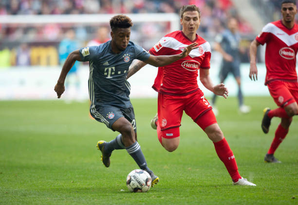 Kingsley Coman of FC Bayern Muenchen Marcel Sobottka of Fortuna Duesseldorf battle for the ball during the Bundesliga match between Fortuna...