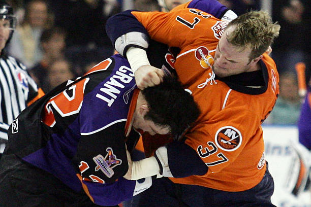 Kip Brennan of the Bridgeport Sound Tigers and Triston Grant of the Philadelphia Phantoms fight during the second period on January 26, 2008 at the...