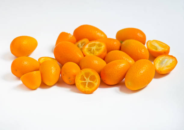 kumquats, halved - kumquat stock pictures, royalty-free photos & images