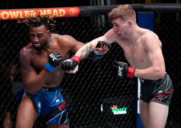 Kyle Daukaus punches Jamie Pickett in their middleweight fight during the UFC Fight Night event at UFC APEX on February 19, 2022 in Las Vegas, Nevada.