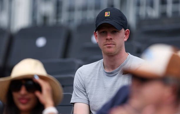 Kyle Edmund of Great Britain watches the First Round match between Daniel Evans of Great Britain and Alexei Popyrin of Australia during Day 2 of the...