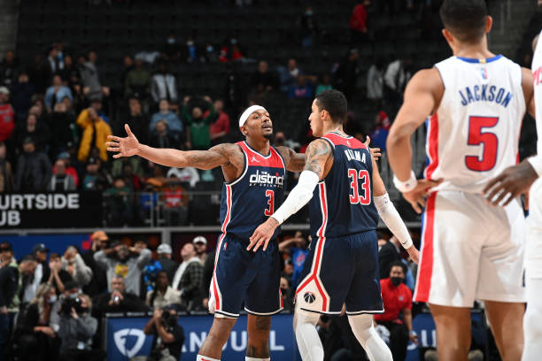 Kyle Kuzma of the Washington Wizards and Bradley Beal of the Washington Wizards react to his three point basket during the game against the Detroit...