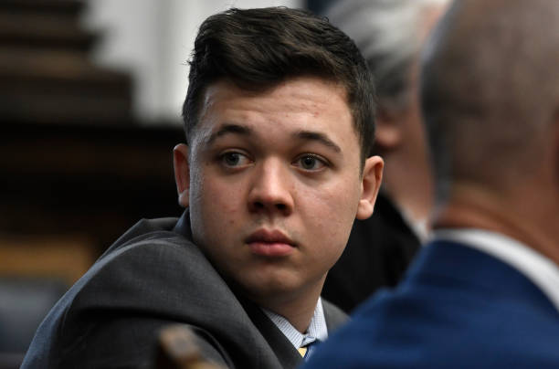 Kyle Rittenhouse looks back as attorneys discuss items in the motion for mistrial presented by his defense during his trial at the Kenosha County...
