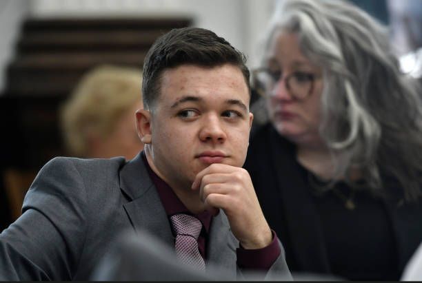 Kyle Rittenhouse sits with his attorneys after a lunch break and waits for proceedings to start at the Kenosha County Courthouse on November 9, 2021...