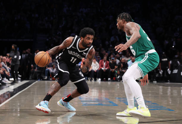 Kyrie Irving of the Brooklyn Nets drives against Marcus Smart of the Boston Celtics during Game Three of the Eastern Conference First Round NBA...