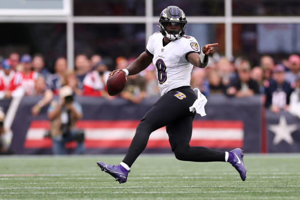 Lamar Jackson of the Baltimore Ravens carries the ball against the New England Patriots at Gillette Stadium on September 25, 2022 in Foxborough,...