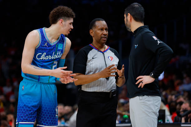 LaMelo Ball and head coach James Borrego of the Charlotte Hornets argue with an official during the second half against the Atlanta Hawks at State...
