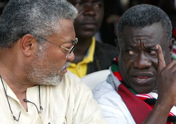 NDC leader and presidential election candidate Pr John Atta Mills talks to former Ghanaian President Jerry Rawlings during a meeting in Accra 04...