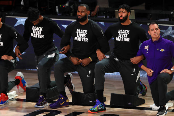 LeBron James of the Los Angeles Lakers along with Anthony Davis of the Los Angeles Lakers kneel during the National Anthem against the Houston...