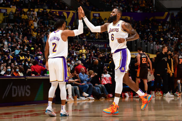 LeBron James of the Los Angeles Lakers high fives Wayne Ellington of the Los Angeles Lakers during the game against the Orlando Magic on December 12,...