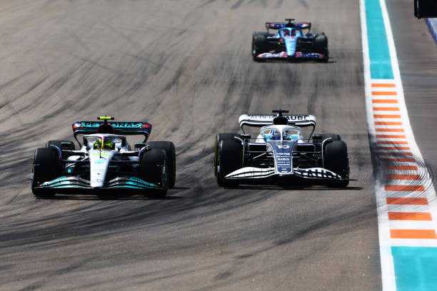 Lewis Hamilton of Great Britain driving the Mercedes AMG Petronas F1 Team W13 and Pierre Gasly of France driving the Scuderia AlphaTauri AT03 battle...