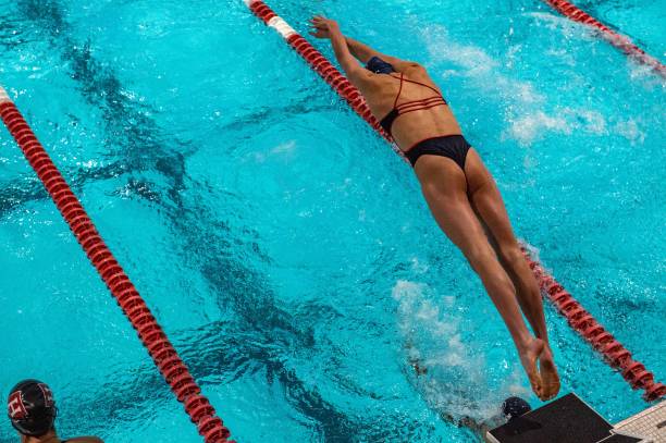 Lia Thomas, a transgender woman, dives into the water to swim in the 200 yard Medley Relay for the University of Pennsylvania at an Ivy League swim...