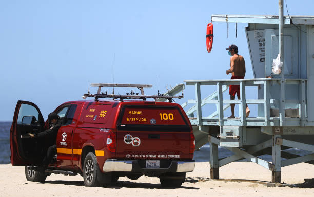 Lifeguard wears a face mask on Santa Monica beach on the day Los Angeles County reopened its beaches, which had been closed due the coronavirus...