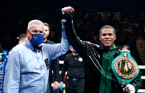 Lightweight champion Devin Haney poses with referee Russell Mora after defeating Joseph Diaz Jr. In a title fight at MGM Grand Garden Arena on...