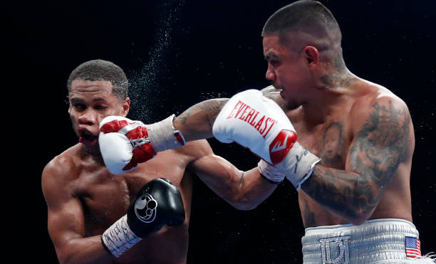 Lightweight champion Devin Haney takes a punch from Joseph Diaz Jr. During a title fight at MGM Grand Garden Arena on December 04, 2021 in Las Vegas,...