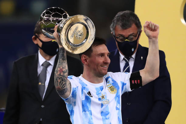 Lionel Messi of Argentina lifts his top scorer award after winning the final of Copa America Brazil 2021 between Brazil and Argentina at Maracana...