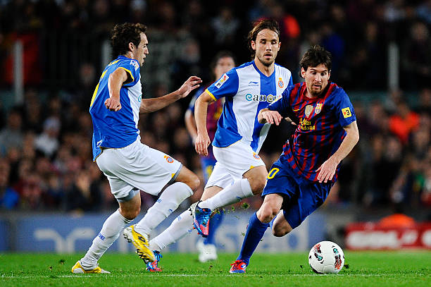 Lionel Messi of FC Barcelona duels for the ball with Raul Baena of RCD Espanyol and Joan Verdu of RCD Espanyol during the La Liga match between FC...