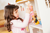 Little Girl with Dollhouse