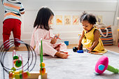 Little kids playing toys in the playroom