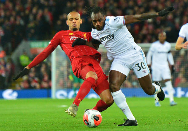 Liverpool's Fabinho vies for possession with West Ham United's Michail Antonio during the Premier League match between Liverpool FC and West Ham...