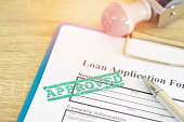 Loan approval, Loan application form with Rubber stamping that says Loan Approved, Financial loan money contract agreement company credit or person.