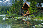 Log cabin hidden in the trees by the Lake Ohara in Canada