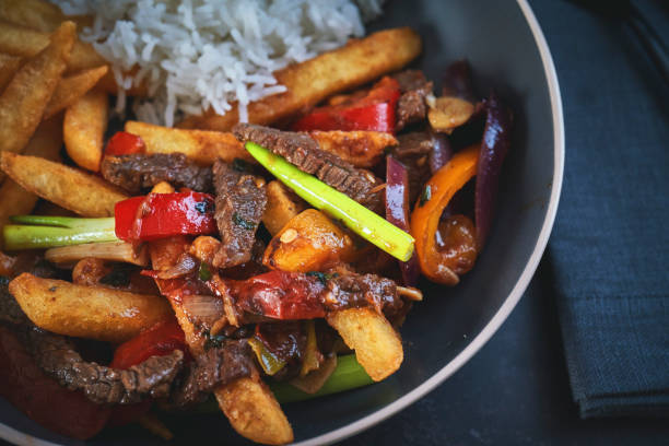 lomo salteado stir fry beef with soy sauce and fried potatoes picture