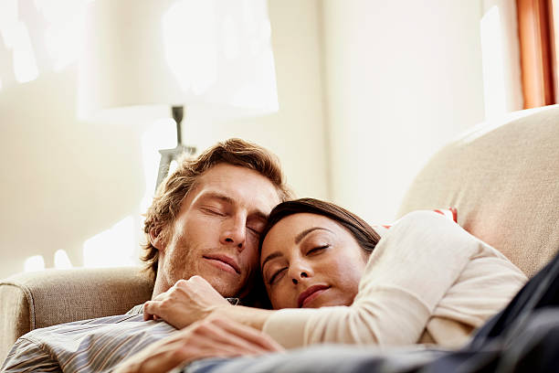 loving couple sleeping on sofa - sleep couple stock pictures, royalty-free photos & images