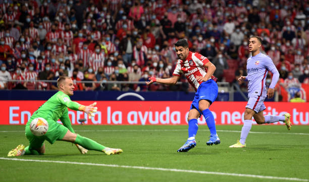 Luis Suarez of Atletico Madrid scores their team's second goal past Marc-Andre ter Stegen of FC Barcelona during the La Liga Santander match between...