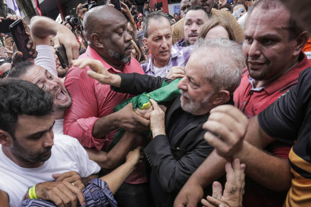Luiz Inacio 'Lula' da Silva former president of Brazil is greeted by supporters as he arrives at a rally outside the Sindicato dos Metalurgicos do...