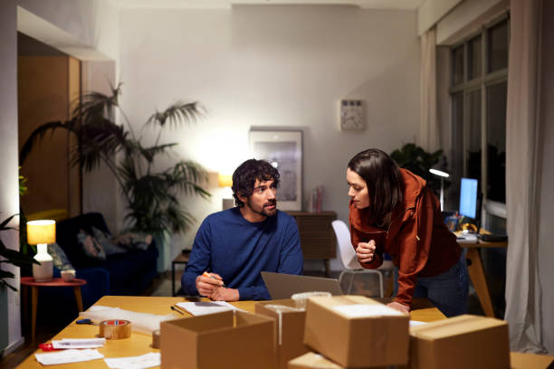 man and woman working late night at home office - couple talking stock pictures, royalty-free photos & images