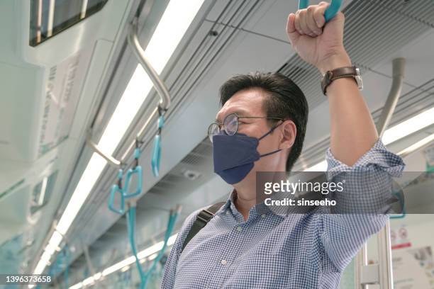 man commuter with face mask holding