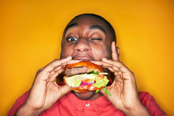 man eating hamburger picture