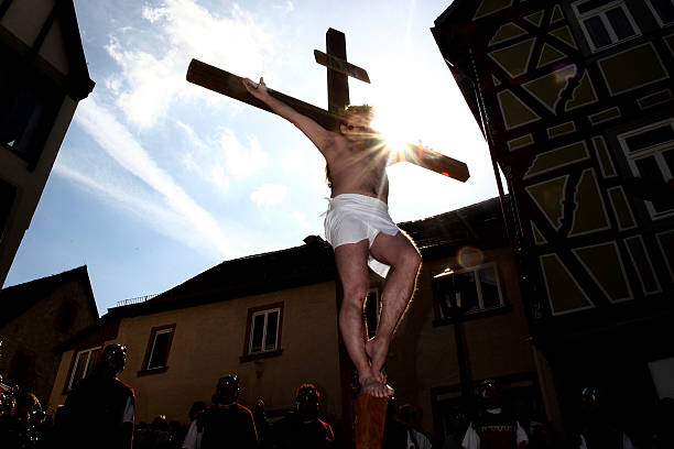Man hangs on a cross during a re-enactment of the crucifixion of Jesus by the Romans on Good Friday on April 2, 2010 in Bensheim, Germany. Christians...