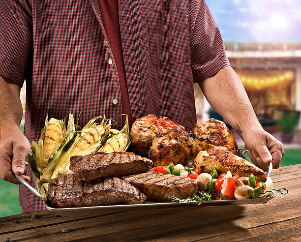 man holding bbq with chicken and rib picture