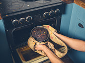Man removing burnt cake from the oven