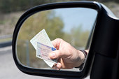 A Man shows Driver's License and Vehicle License during a Check