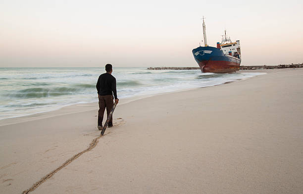 Man walking towards the grounded ship