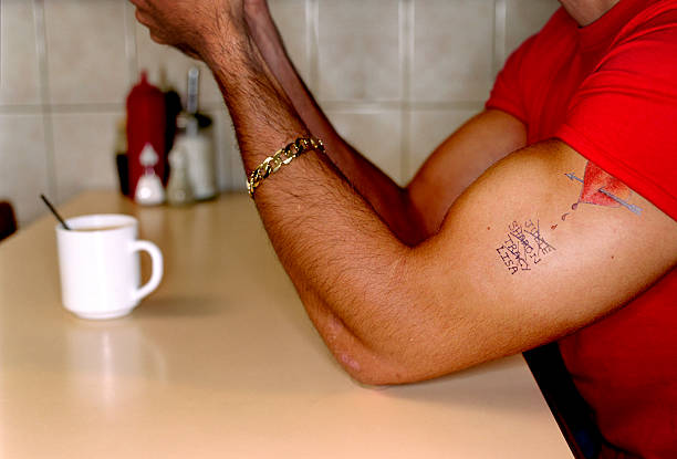 Man with tattoo in cafe