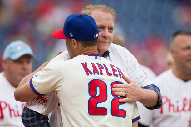 Manager Gabe Kapler of the Philadelphia Phillies hugs former pitcher Curt Schilling prior to the game against the Milwaukee Brewers at Citizens Bank...