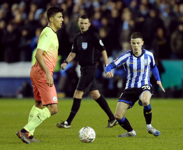 Sheffield Wednesday's English head coach Garry Monk and Manchester City's Spanish manager Pep Guardiola watches his players from the touchline during...