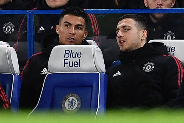 Manchester United's Portuguese striker Cristiano Ronaldo and Manchester United's Portuguese defender Diogo Dalot chat from their seats on the...