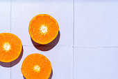 mandarin orange slices white tile background