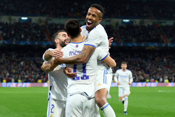 Marco Asensio of Real Madrid celebrates with Eder Militao and Daniel Carvajal after scoring their team's second goal during the UEFA Champions League...